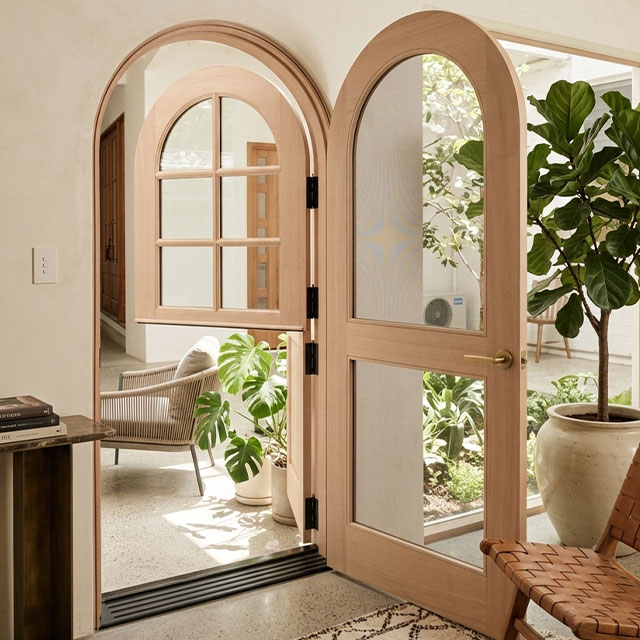 Custom arched timber Dutch door with screen 
